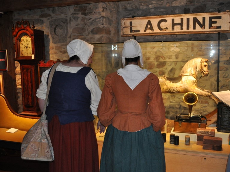 Museum volunteers examining exhibited objects